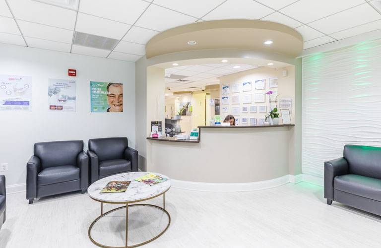 a living room with a couch, chairs, and a table  at RTC Dental in Great Falls for Reston dental office services.