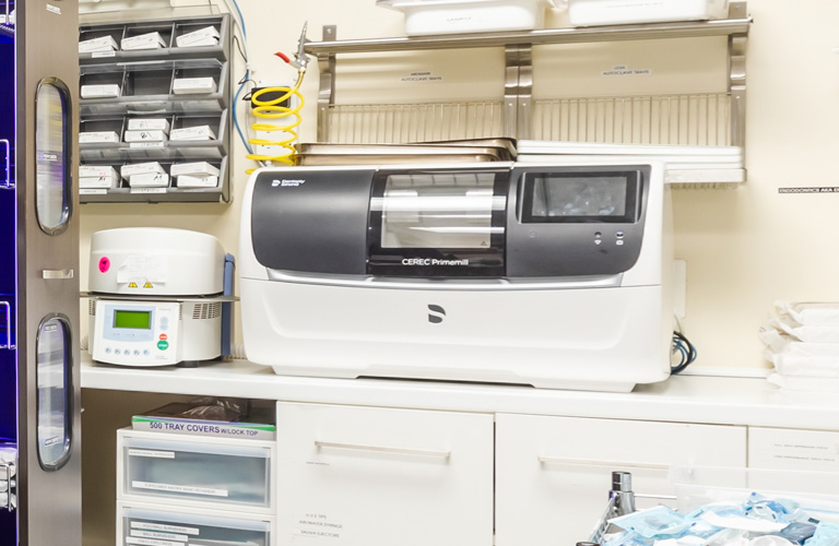 a kitchen with a microwave and a shelf full of items  at RTC Dental in Great Falls for Reston dental office services.