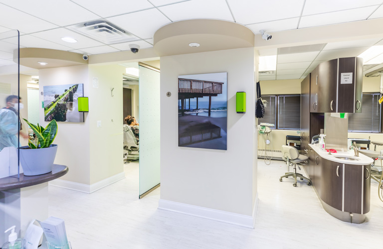 a kitchen with a refrigerator, sink, and a counter  at RTC Dental in Reston, VA for Emergency dentist Reston services.