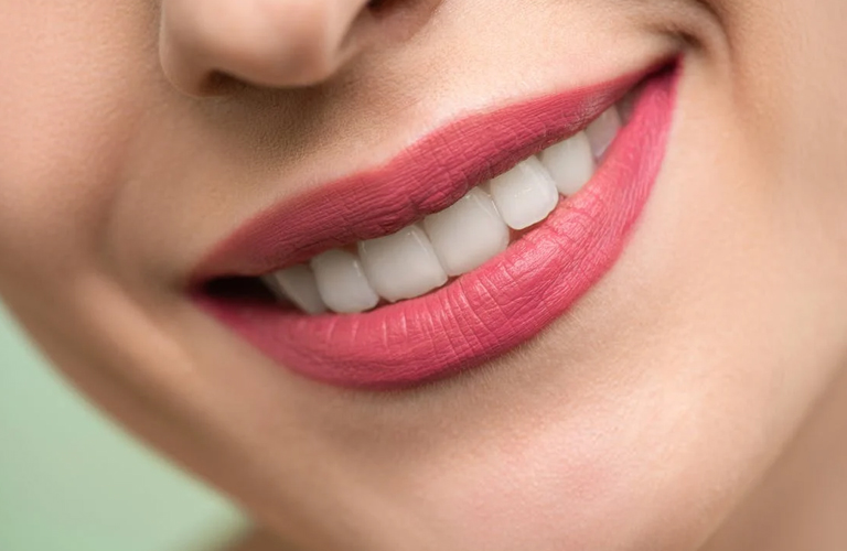 a woman is smiling at RTC Dental in Oakton for Dental implants Reston services.