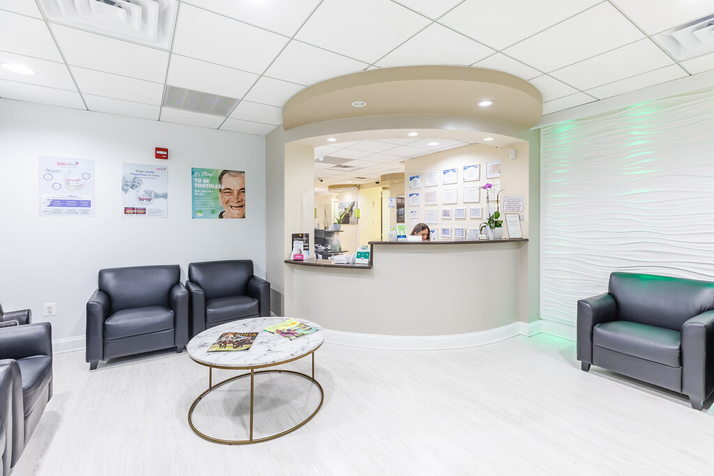 a living room with a couch, chair, and table  at RTC Dental in McLean for Invisalign Reston services.