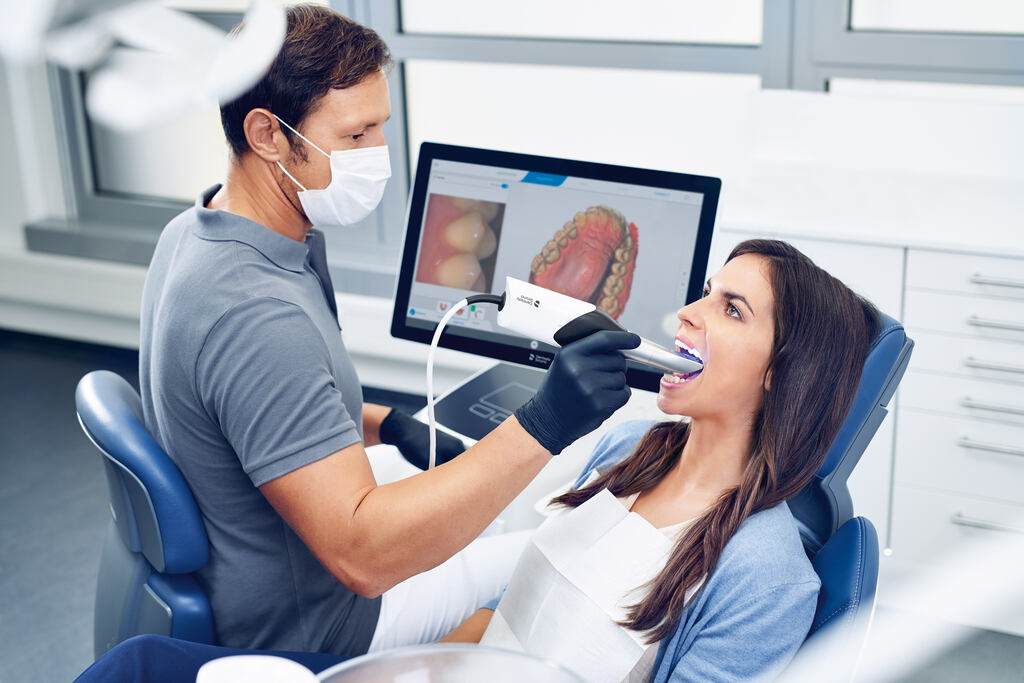 a woman is blow drying a man's hair  at RTC Dental in Reston, VA for Emergency dentist Reston services.