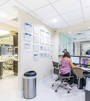 a woman sitting at a desk in a cubicle  at RTC Dental in Great Falls for Reston dental office services.