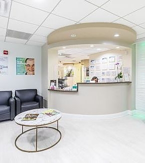 a living room with a couch, chair, and table  at RTC Dental in McLean for Invisalign Reston services.