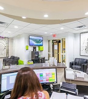 a woman is looking at a computer screen  at RTC Dental in Reston, VA for Dentist Reston VA services.