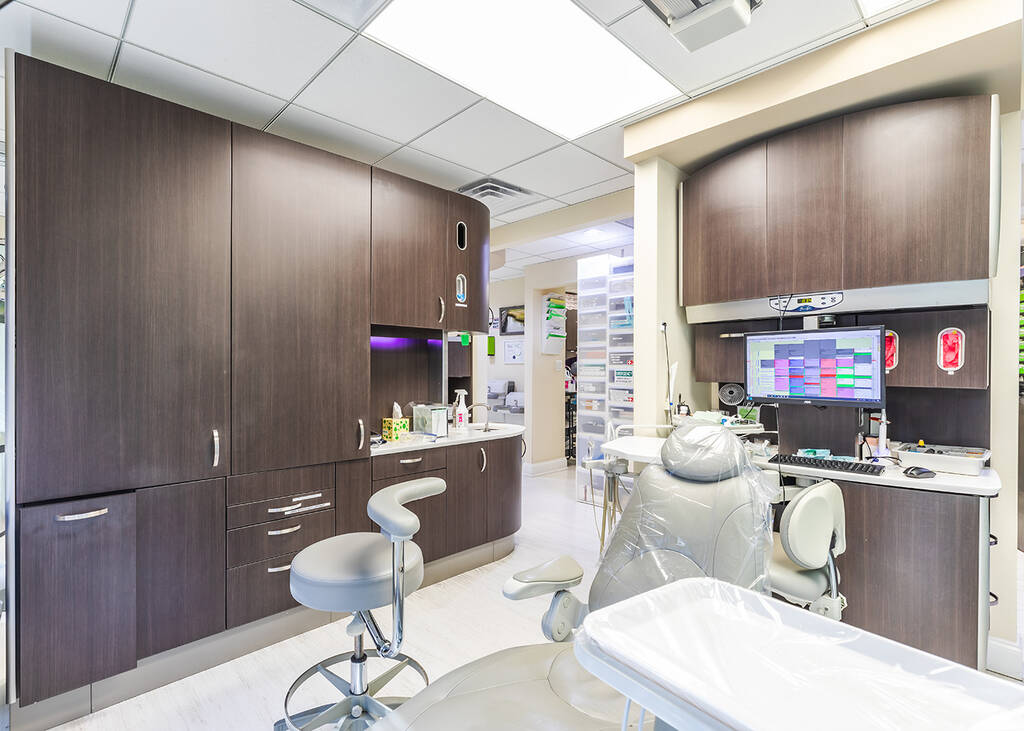 a kitchen with a sink, a chair, and a mirror  at RTC Dental in Sterling for Cosmetic dentist Reston services.