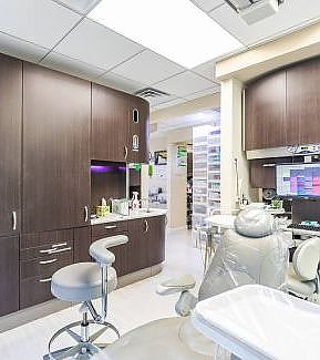 a kitchen with a sink, a chair, and a mirror  at RTC Dental in Sterling for Cosmetic dentist Reston services.