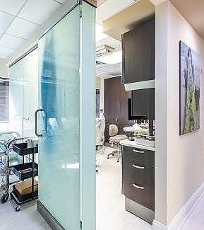 a kitchen with a refrigerator, microwave, and a television  at RTC Dental in Reston, VA for Dentist Reston VA services.