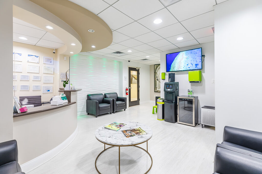 a living room with a couch, table, and a tv  at RTC Dental in Chantilly for Pediatric dentist Reston services.