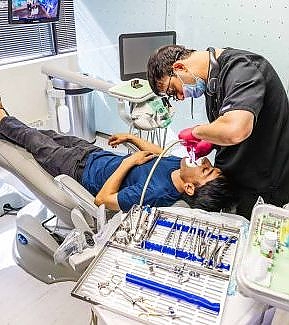 a man and a woman laying on a bed  at RTC Dental in Reston, VA for Emergency dentist Reston services.