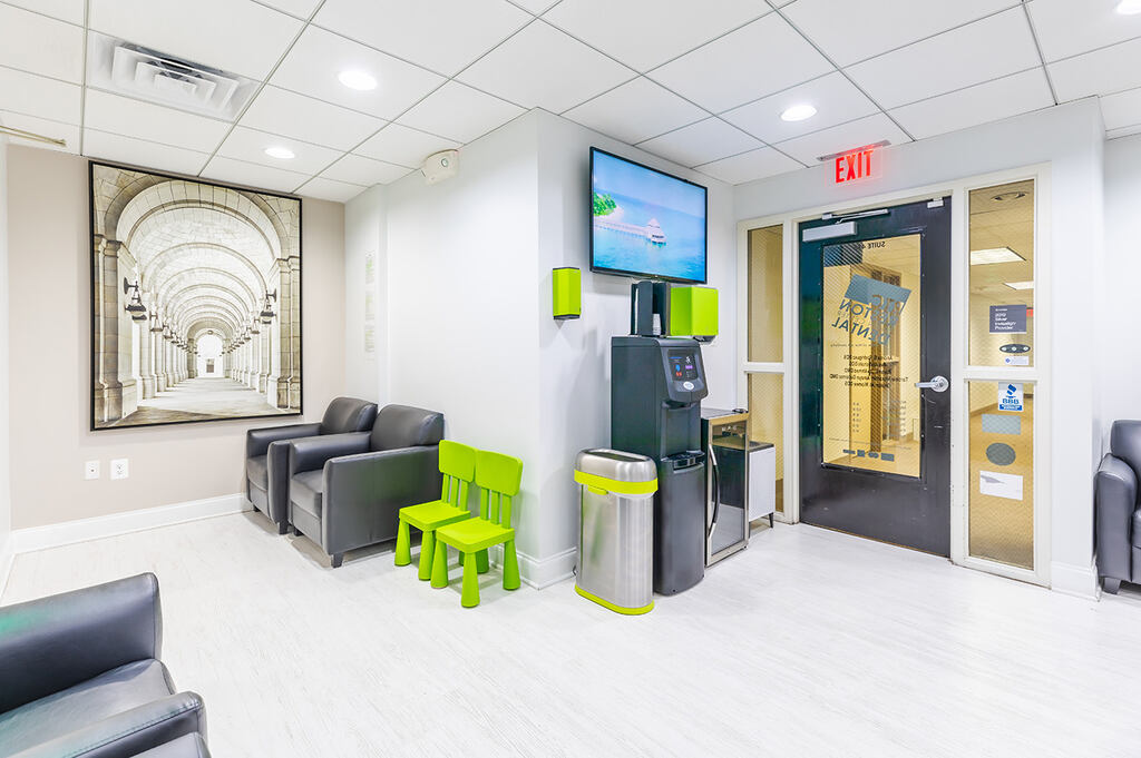 a living room with a couch, chair, and a television  at RTC Dental in Ashburn for RTC Dental Reston services.