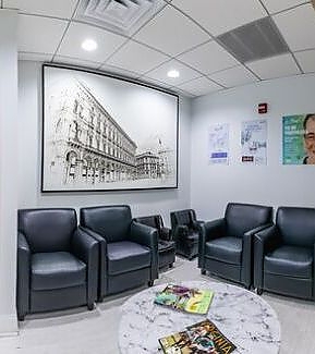 a living room with a couch, chairs and a television  at RTC Dental in Vienna for Family dentistry Reston services.