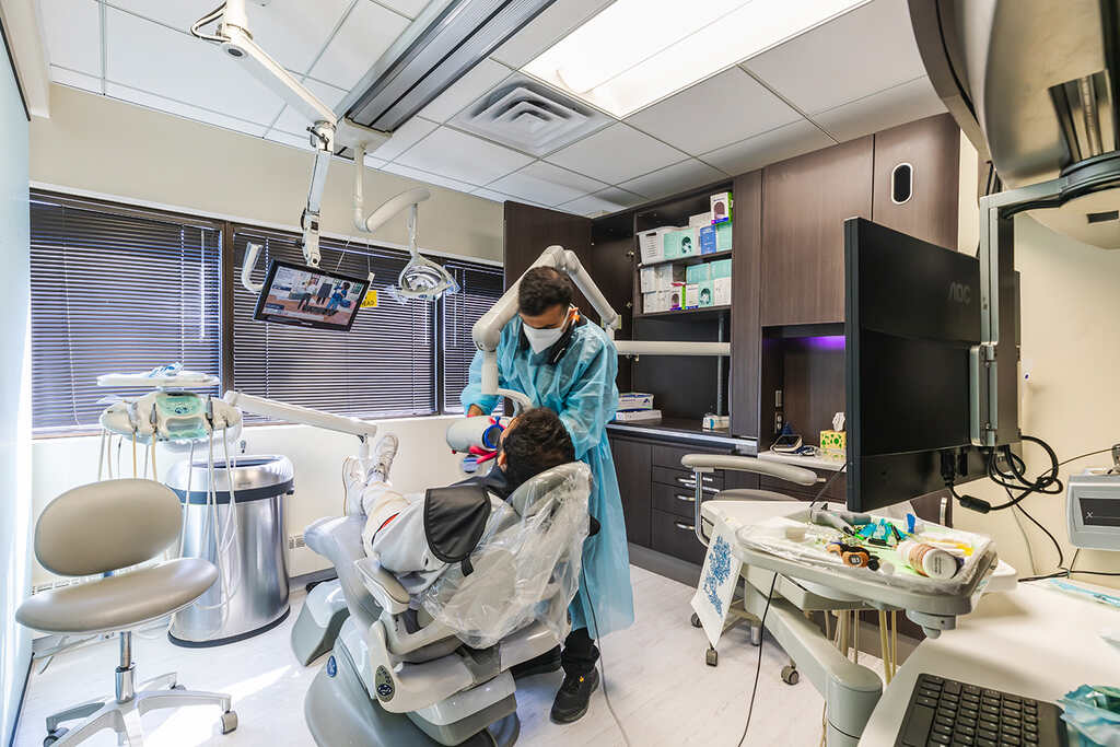 a woman in a hospital room with a large metal object  at RTC Dental in Great Falls for Reston dental office services.