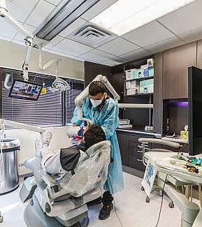 a woman in a hospital room with a large metal object  at RTC Dental in Great Falls for Reston dental office services.