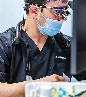  a man wearing a helmet and goggles is using a computer  at RTC Dental in Vienna for Family dentistry Reston services.