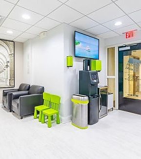 a living room with a couch, chair, and a television  at RTC Dental in Ashburn for RTC Dental Reston services.