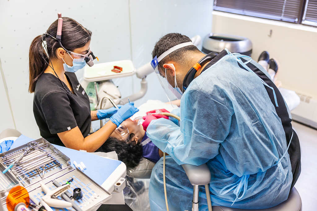 a hospital room with a nurse and a patient  at RTC Dental in Reston, VA for Emergency dentist Reston services.