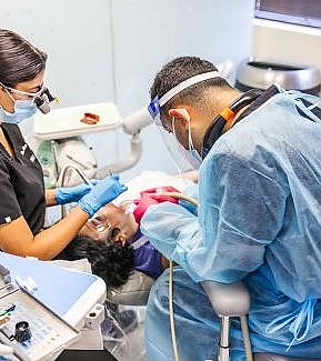 a hospital room with a nurse and a patient  at RTC Dental in Reston, VA for Emergency dentist Reston services.