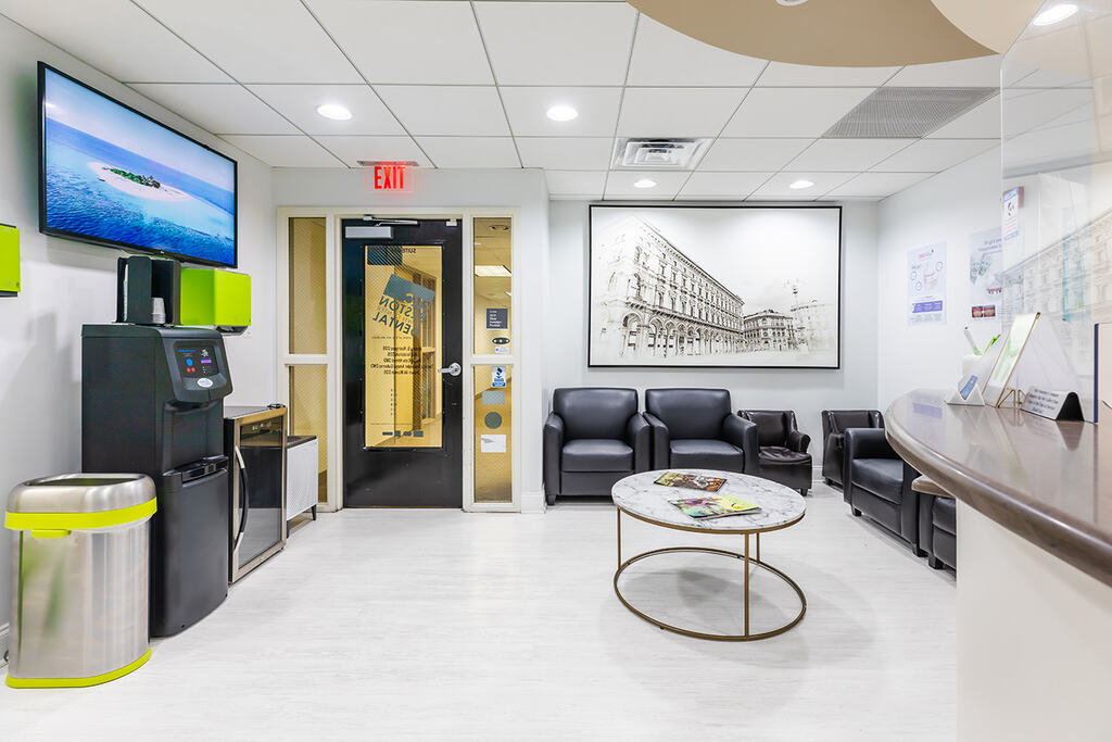 a living room with a couch, chairs, and a table  at RTC Dental in Great Falls for Reston dental office services.