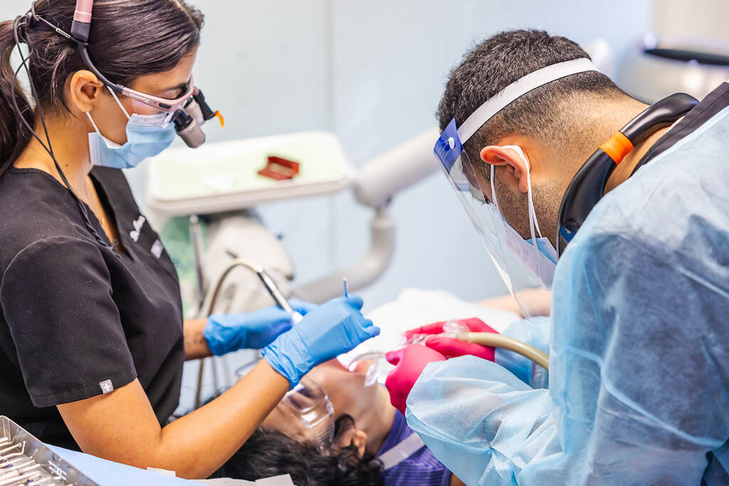 a nurse is cutting a patient's neck  at RTC Dental in Chantilly for Pediatric dentist Reston services.