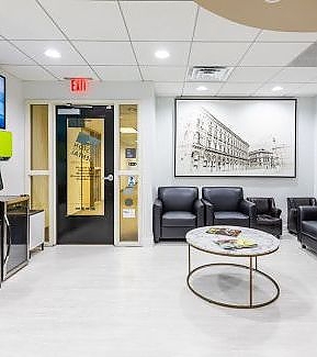 a living room with a couch, chairs, and a table  at RTC Dental in Great Falls for Reston dental office services.