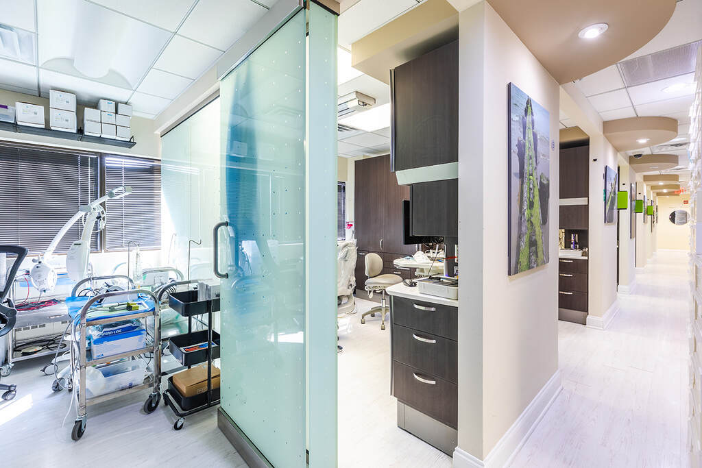 a kitchen with a refrigerator, microwave, and a television  at RTC Dental in Vienna for Family dentistry Reston services.