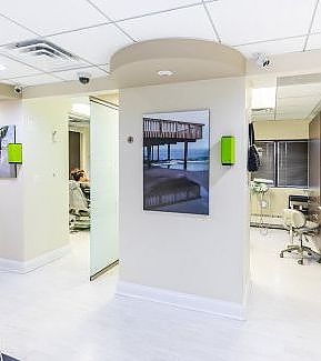 a room with a wall with a wall of pictures on it  at RTC Dental in Oakton for Dental implants Reston services.